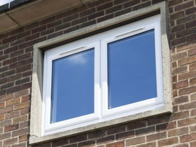 small white casement window on the outside of a home