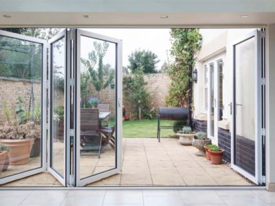 white aluminium bifolding doors opening into a garden