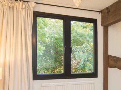 Black OW-80 Aluminium Casement Window in neutral coloured room